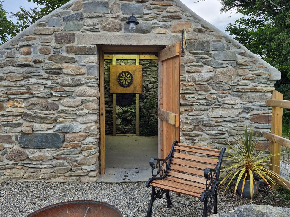 An outdoor darts area with a bench at Annie’s Farm Cottage near Londonderry, Northern Ireland