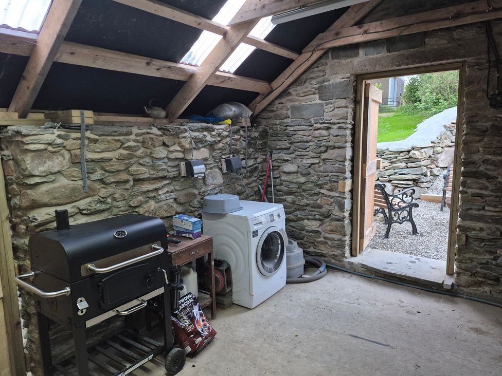 A utility room with a washing machine and grill at Annie’s Farm Cottage near Londonderry, Northern Ireland