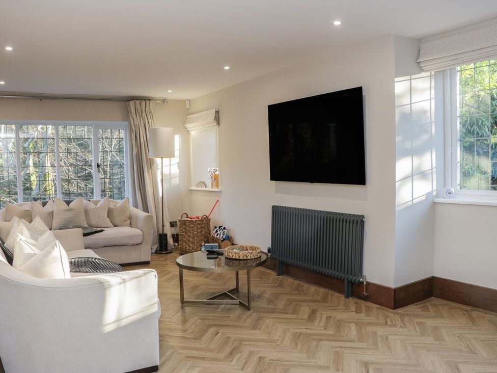 A living room with a sofa and television at North Cottage in Bowness-On-Windermere