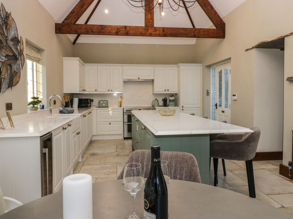 A kitchen with an island and appliances at North Cottage in Bowness-On-Windermere
