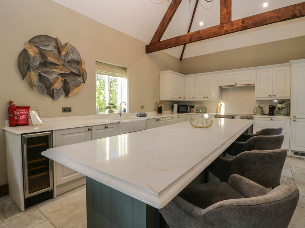 A kitchen with a large island and appliances at North Cottage in Bowness-On-Windermere