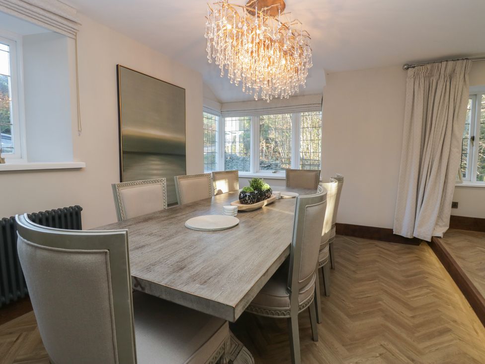 A dining room with a table and chairs at North Cottage in Bowness-On-Windermere