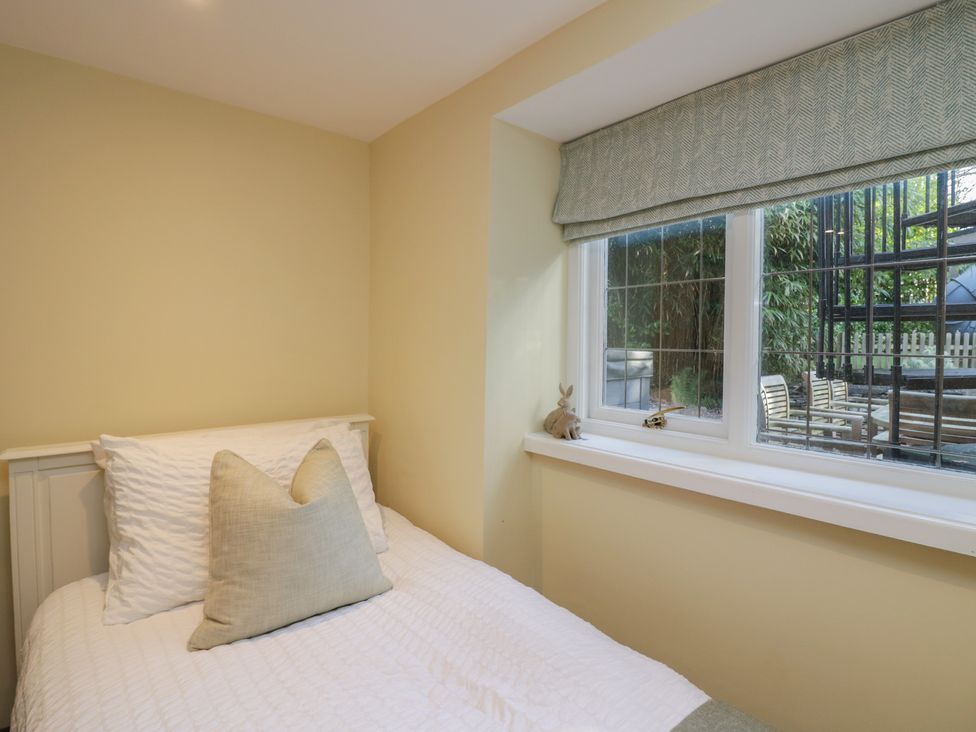 A bedroom with a single bed and a window at North Cottage Bowness-On-Windermere