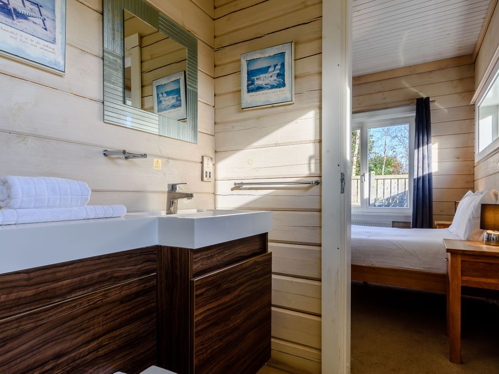 A bathroom with a sink and towels at Chestnut Spa Carlton Miniott near Thirsk