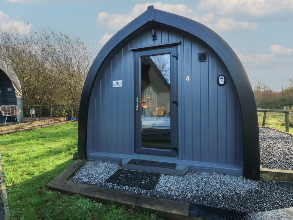 A cabin with a door and window in front at Garden Lodge 4 Swansea
