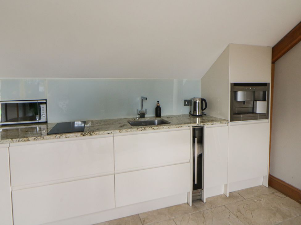 A kitchen with a sink and appliances at Rose Apartment Oldwalls near Reynoldston