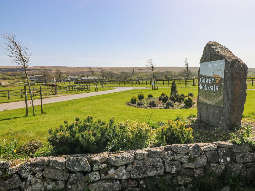 A stone sign at Gower Retreats with a view of the landscape at Willow Apartment Oldwalls, Llanrhidian, Gower