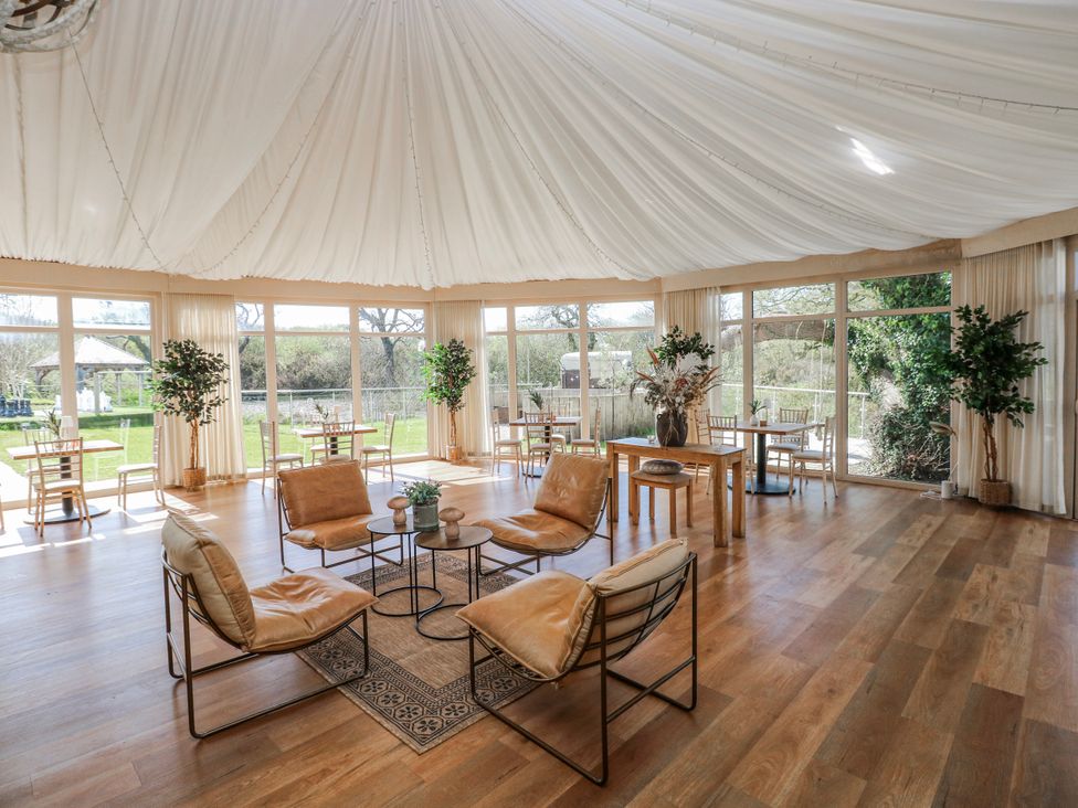 A spacious room with seating and tables at Ivy Cottage Oldwalls, Llanrhidian, Gower