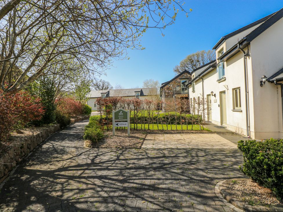 An outdoor view with a sign and pathway at Ivy Cottage Oldwalls, Llanrhidian, Gower