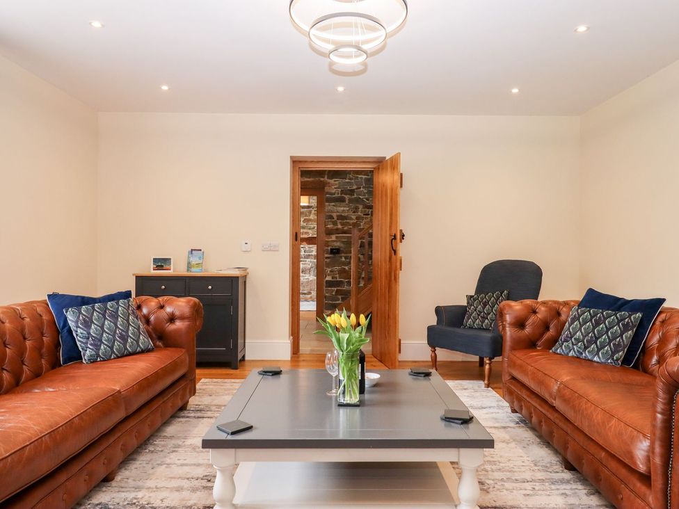 A living room with sofas and a coffee table at Knowle House in Okehampton