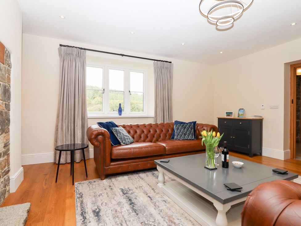 A living room with a sofa and coffee table at Knowle House in Okehampton