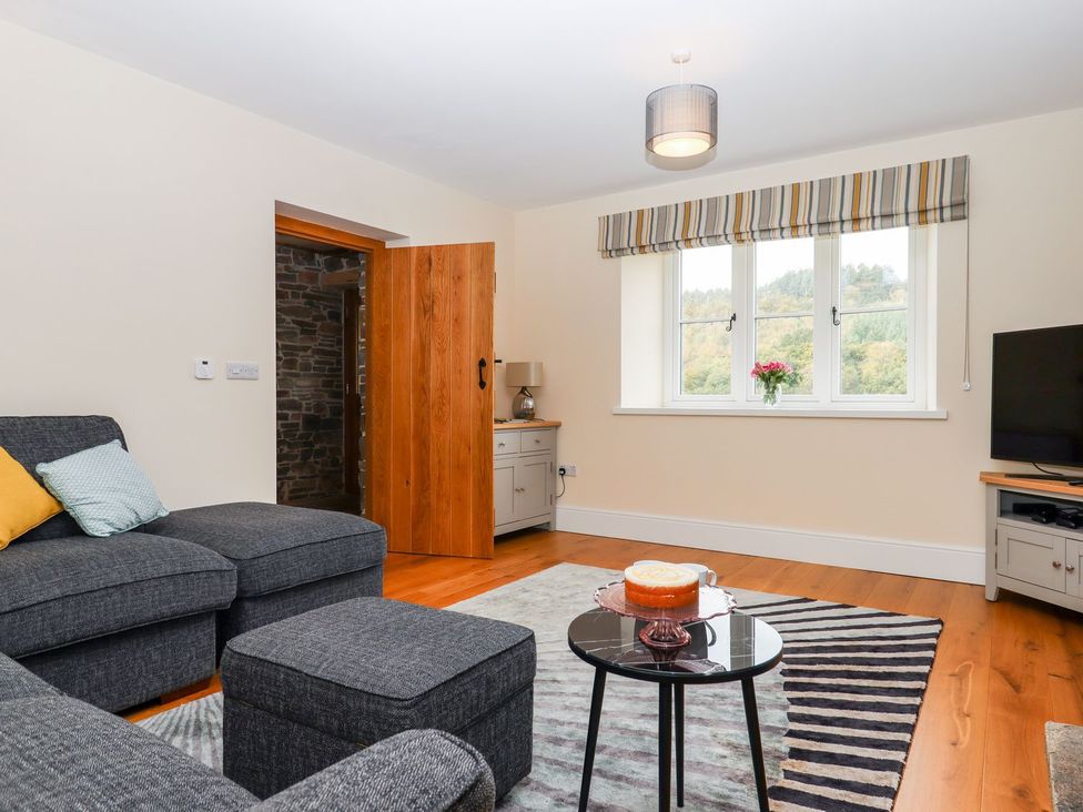 A living room with a sofa and coffee table at Knowle House in Okehampton