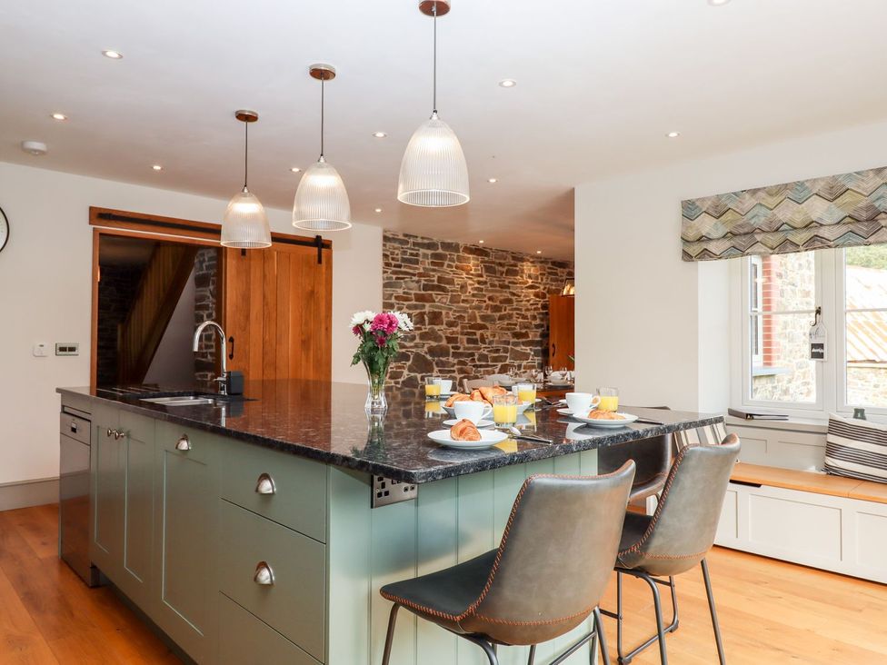 A kitchen with a large island and tableware at Knowle House in Okehampton