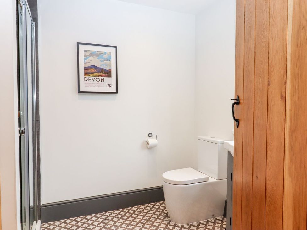A bathroom with a toilet and sink at Knowle House Okehampton