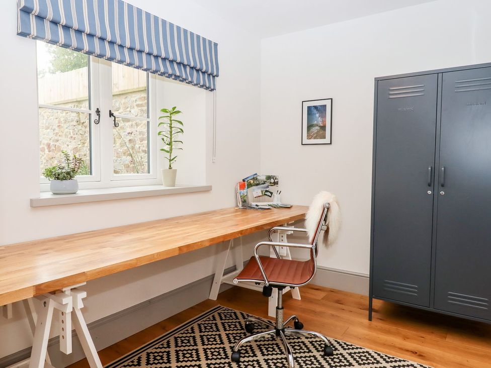An office with a desk and chair at Knowle House in Okehampton