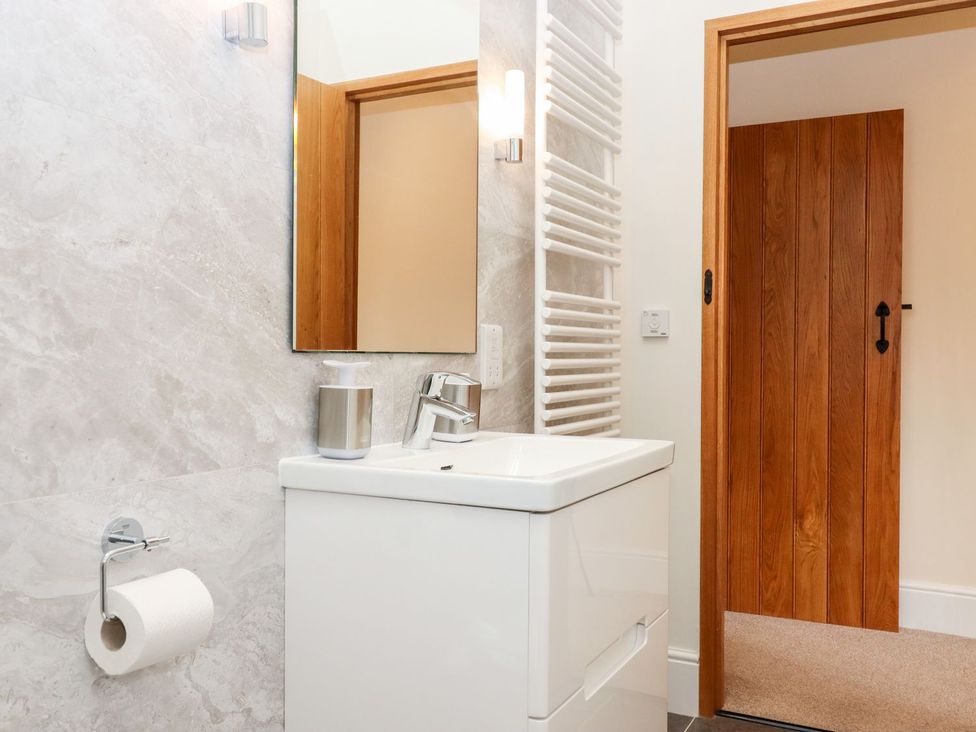 A bathroom with a wash basin and towel radiator at Knowle House Okehampton