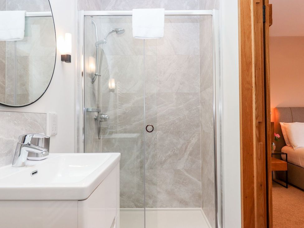 A bathroom with a shower and sink at Knowle House in Okehampton