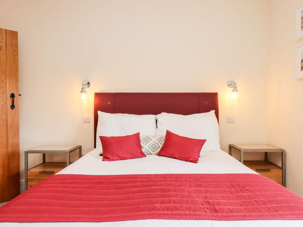 A bedroom with a bed and bedside tables at Knowle House Okehampton