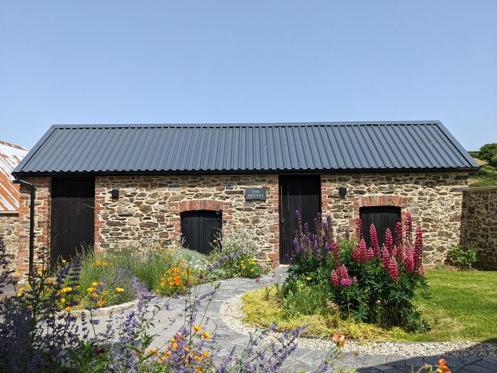 A stone building with a garden at The Piggery in Okehampton