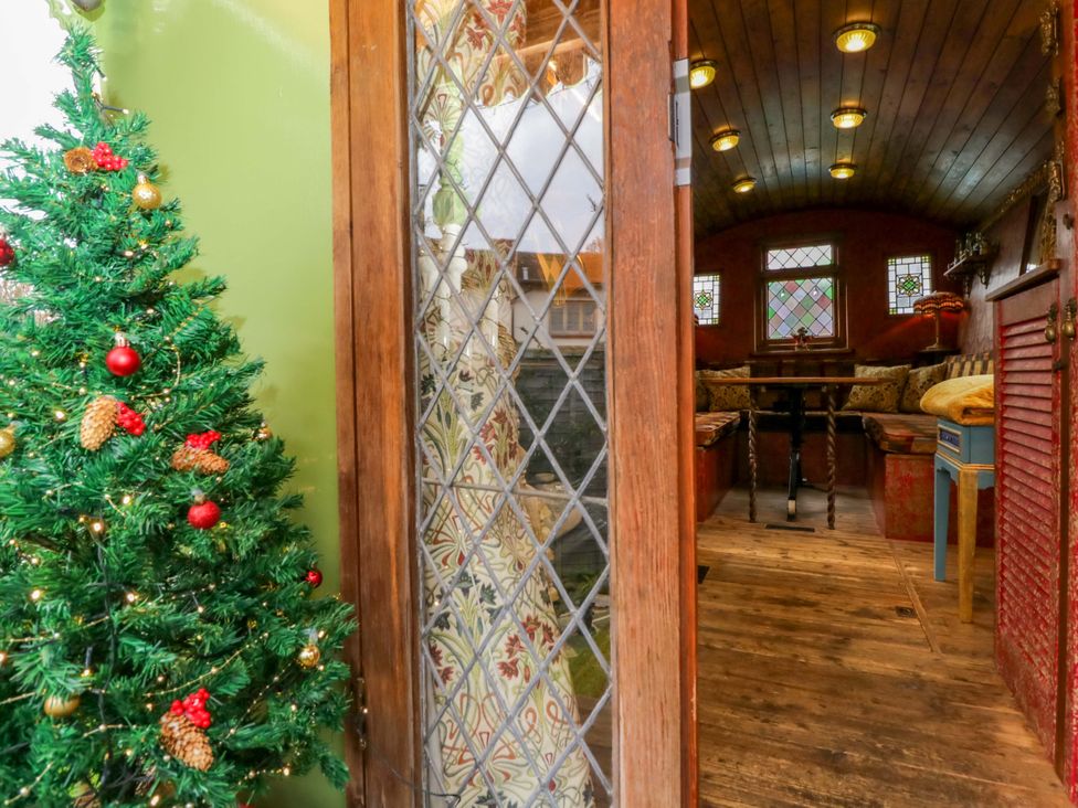A snug with a Christmas tree and wooden furniture at The Gypsy Caravan in Marlborough