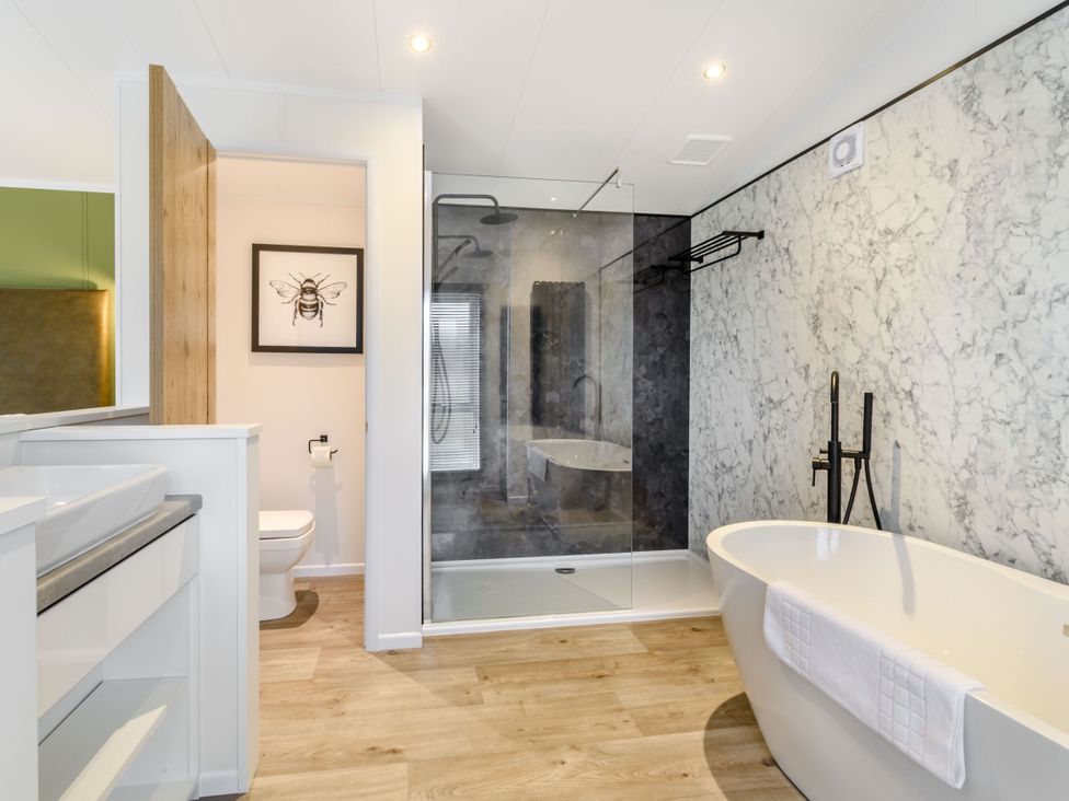 A bathroom with sink, toilet, shower, and bathtub at Pear Tree Spa in Carlton Miniott near Thirsk