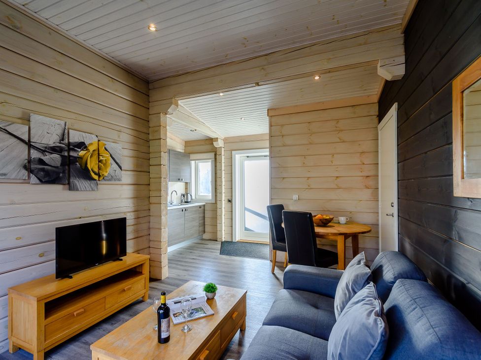 A living room with a sofa and television at Chestnut Spa (Pet) Carlton Miniott near Thirsk