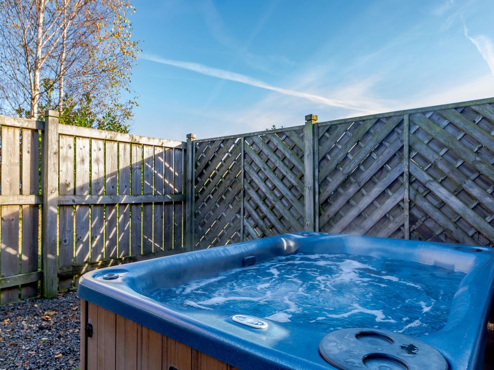 A hot tub with a wooden fence at Chestnut Spa (Pet) Carlton Miniott near Thirsk