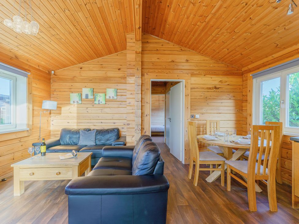 A living room with a sofa and dining table at Yew Tree Spa (Pet) Carlton Miniott near Thirsk