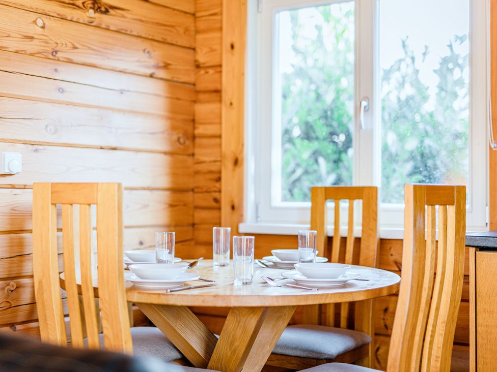 A dining room with a table and chairs at Yew Tree Spa (Pet) Carlton Miniott near Thirsk