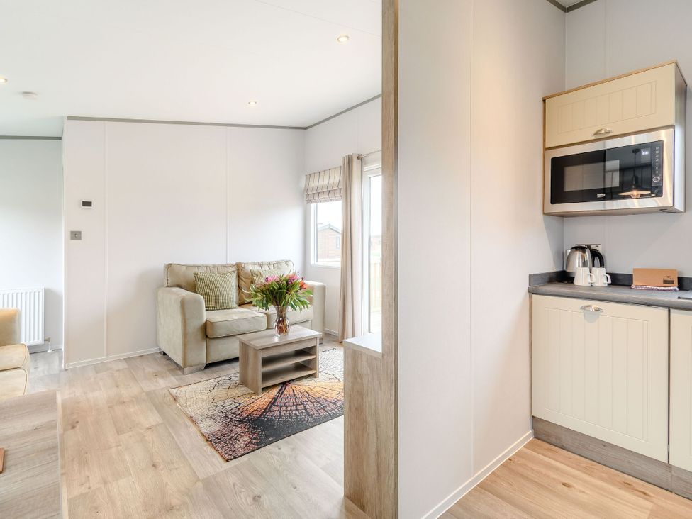 A living room with a sofa and coffee table at Cedar in Carlton Miniott near Thirsk