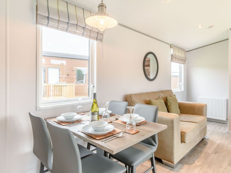 A dining room with a table set for dinner at Cedar in Carlton Miniott near Thirsk