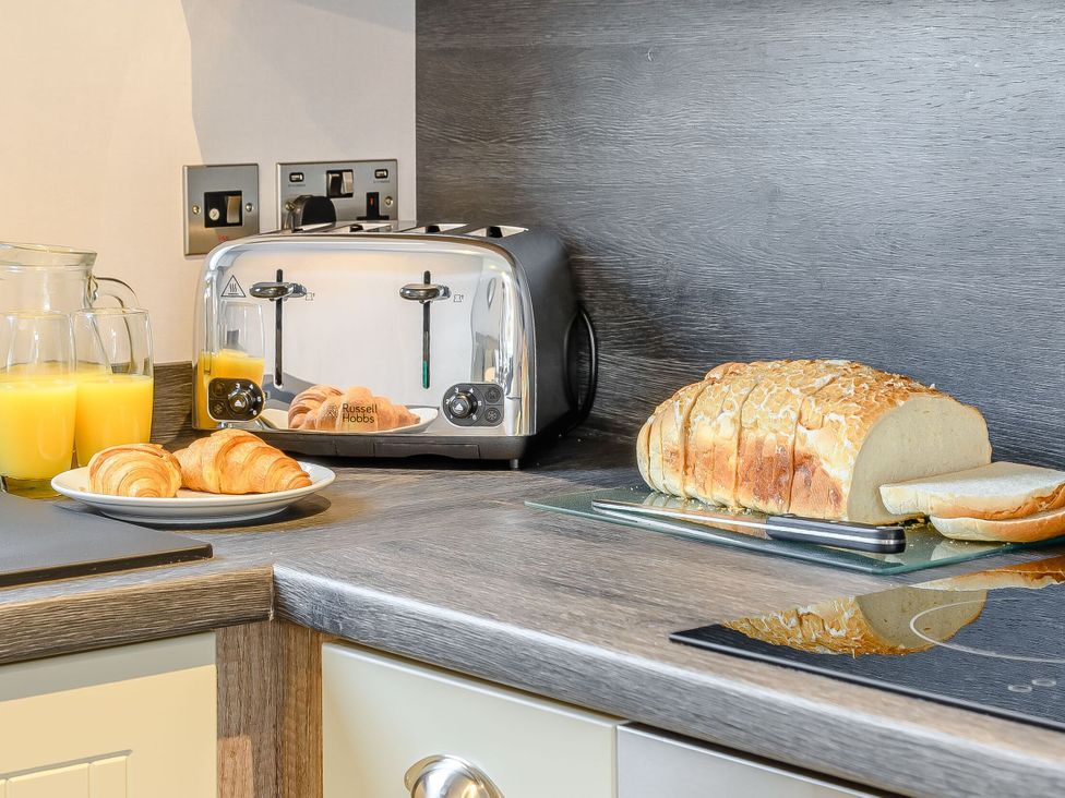A kitchen counter with a toaster and food items at Cedar in Carlton Miniott near Thirsk