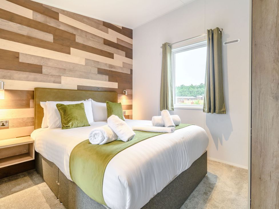 A bedroom with a bed and window at Cedar in Carlton Miniott near Thirsk