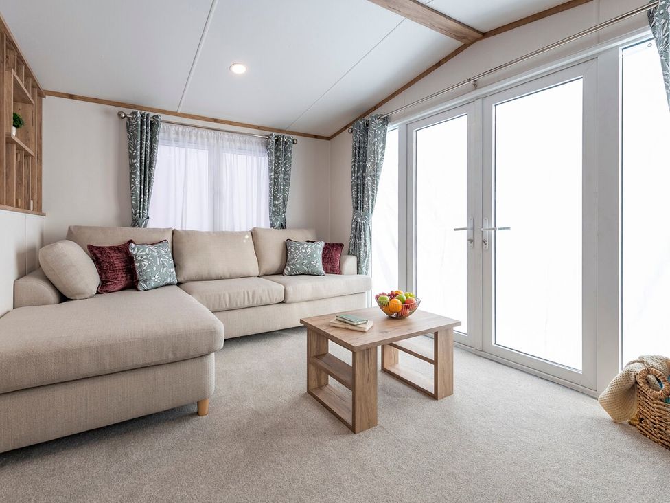 A living room with a sofa and coffee table at Ellery Waterside Spa Carlton Miniott near Thirsk