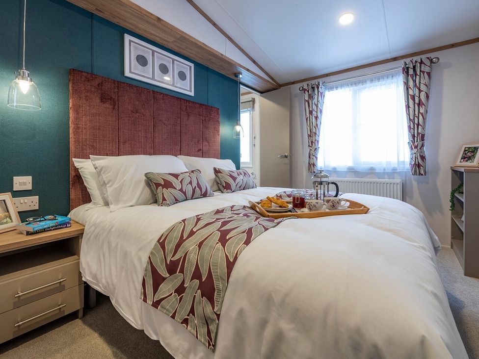 A bedroom with a bed and tray on it at Ellery Waterside Spa Carlton Miniott near Thirsk