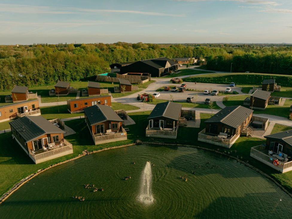 An outdoor view of lodges and fountain at Birch Waterside Spa Carlton Miniott near Thirsk