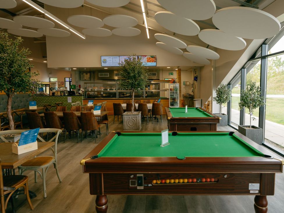 A dining area with pool tables and seating at Birch Waterside Spa Carlton Miniott near Thirsk