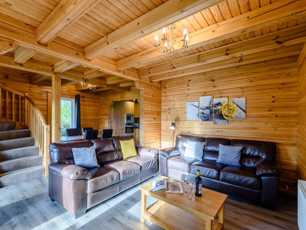 A living room with brown sofas and a coffee table at Birch Spa Carlton Miniott near Thirsk