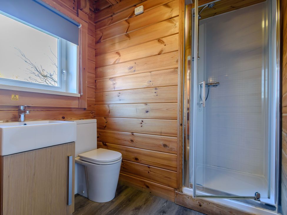A bathroom with a sink, toilet, and shower at Birch Spa in Carlton Miniott near Thirsk