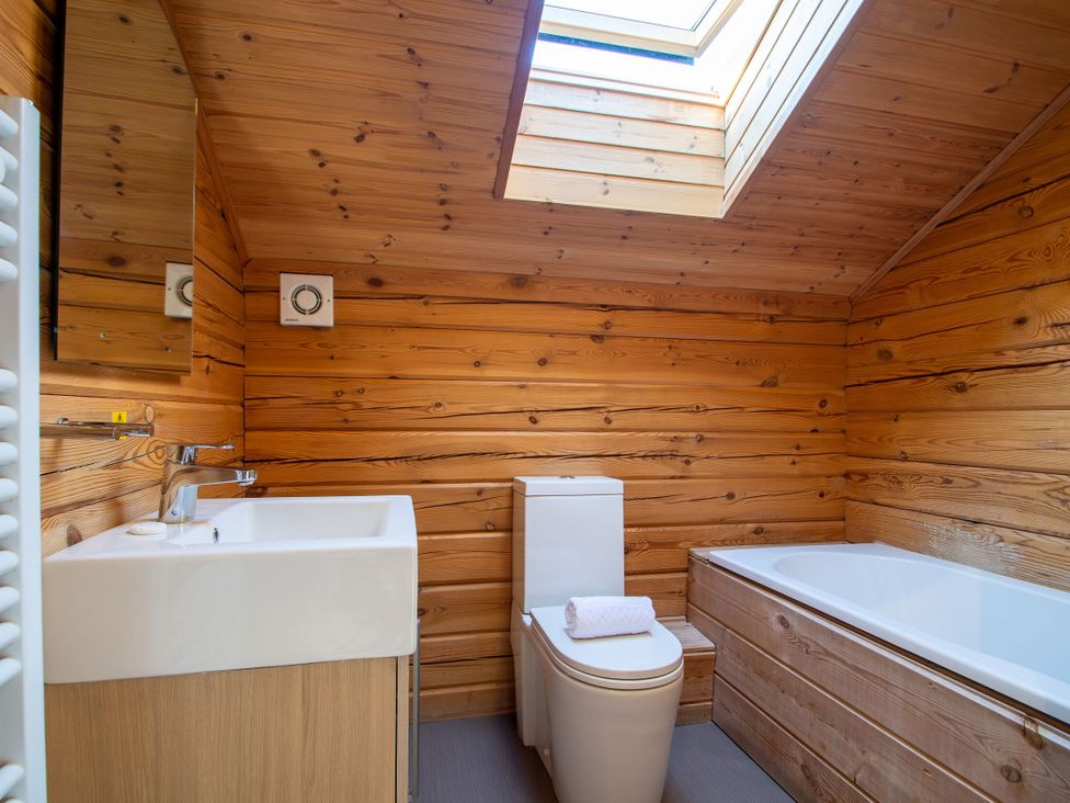 A bathroom with a toilet, sink and bathtub at Birch Spa Carlton Miniott near Thirsk