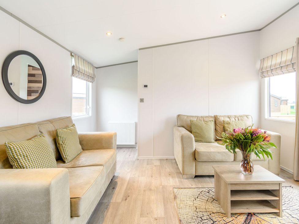A living room with a sofa and coffee table at Cedar Spa in Carlton Miniott near Thirsk