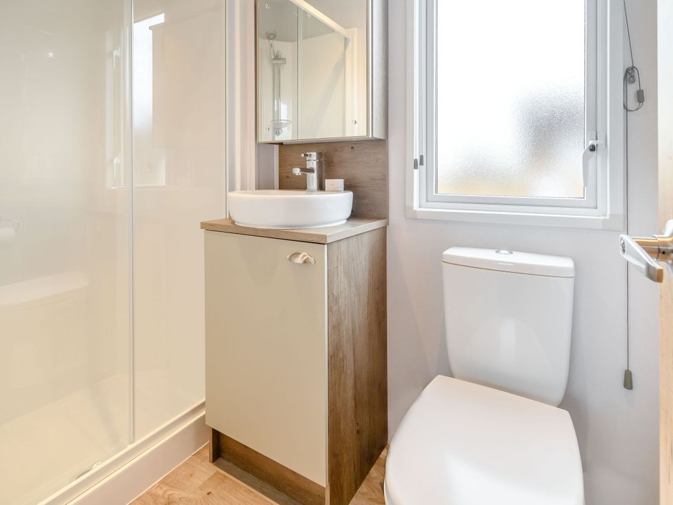A bathroom with a sink and toilet at Cedar Spa Carlton Miniott near Thirsk