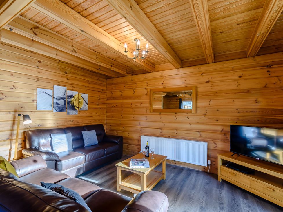 A living room with a sofa and television at Birch Waterside Spa (Pet) Carlton Miniott near Thirsk