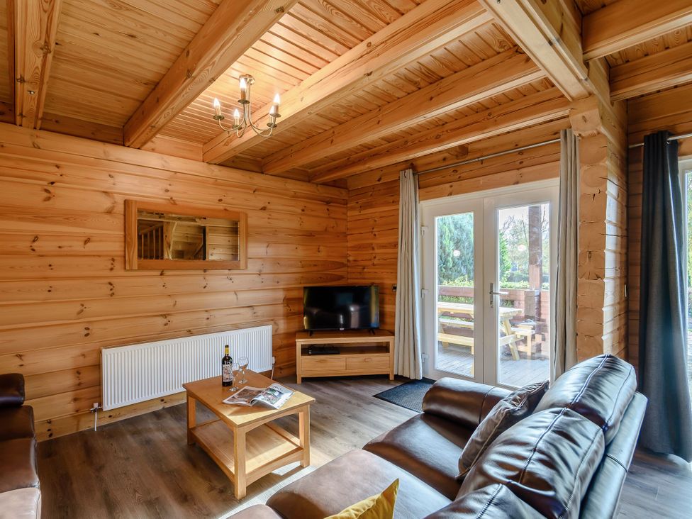 A living room with a sofa and coffee table at Birch Waterside Spa (Pet) Carlton Miniott near Thirsk