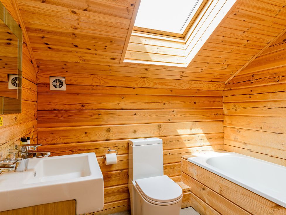 A bathroom with wooden walls and fixtures at Birch Waterside Spa (Pet) Carlton Miniott near Thirsk