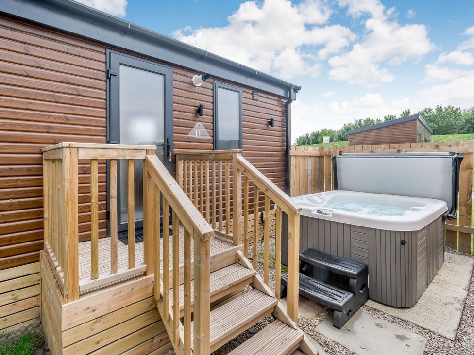 An outdoor area with a hot tub and staircase at Cedar Spa (Pet) Carlton Miniott near Thirsk