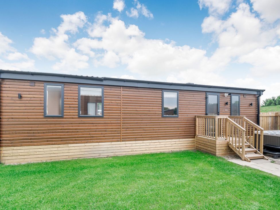 A wooden structure with steps and windows at Cedar Spa (Pet) Carlton Miniott near Thirsk