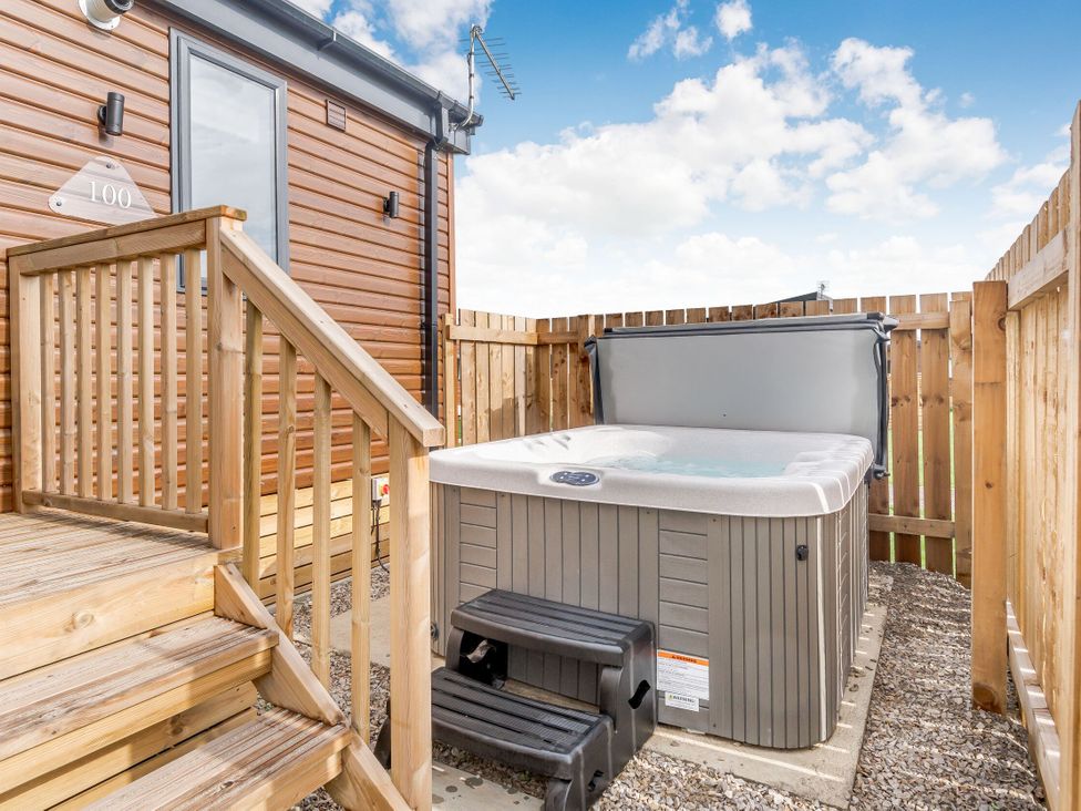 An outdoor area with a hot tub and steps at Kinder Spa in Carlton Miniott near Thirsk
