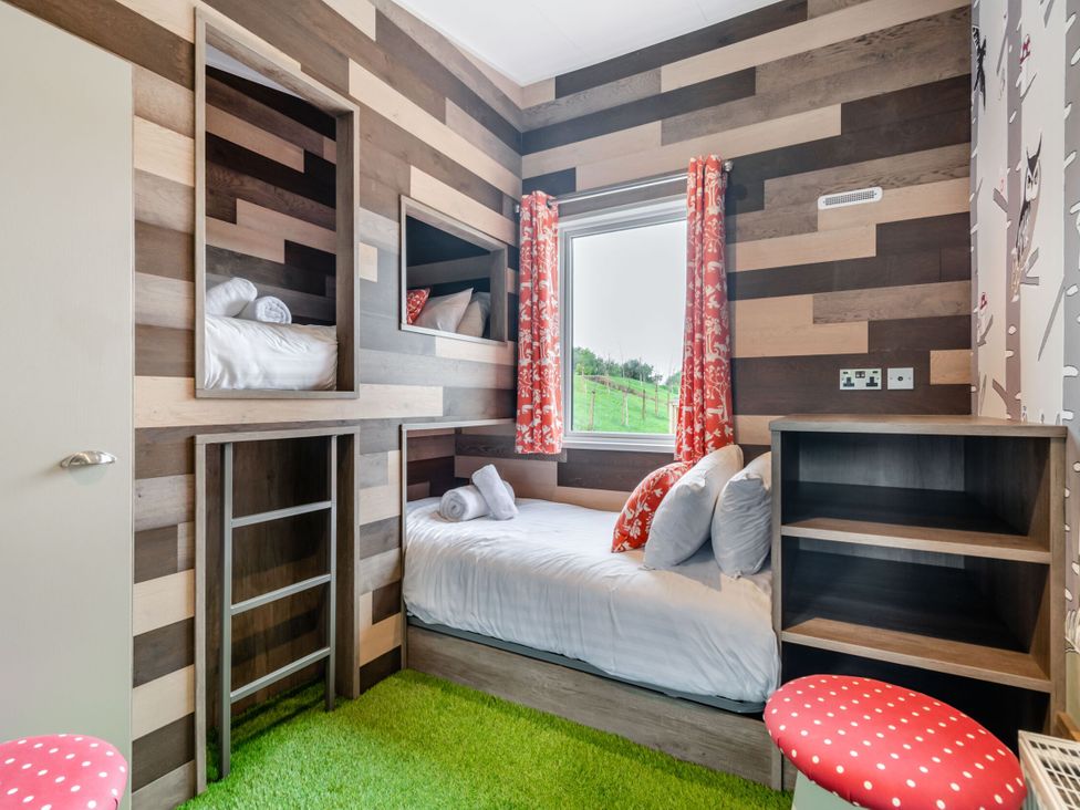 A bedroom with a bed and bunk bed at Kinder Spa Carlton Miniott near Thirsk