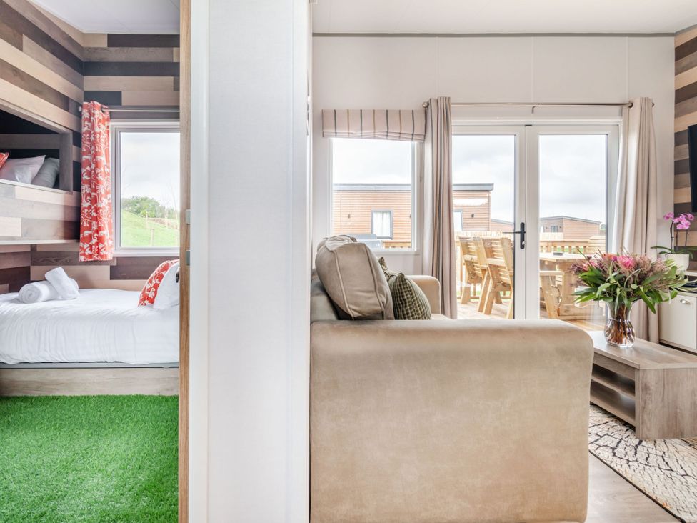 A living room and bedroom with furniture at Kinder Spa Carlton Miniott near Thirsk